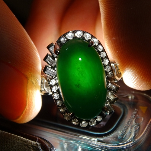 647 - An unmarked white gold cabochon jadeite and diamond cluster cocktail ring, jadeite measures: length ... 