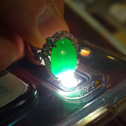 647 - An unmarked white gold cabochon jadeite and diamond cluster cocktail ring, jadeite measures: length ... 