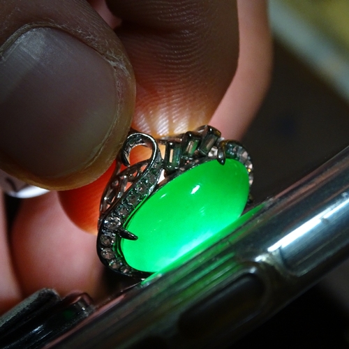 647 - An unmarked white gold cabochon jadeite and diamond cluster cocktail ring, jadeite measures: length ... 