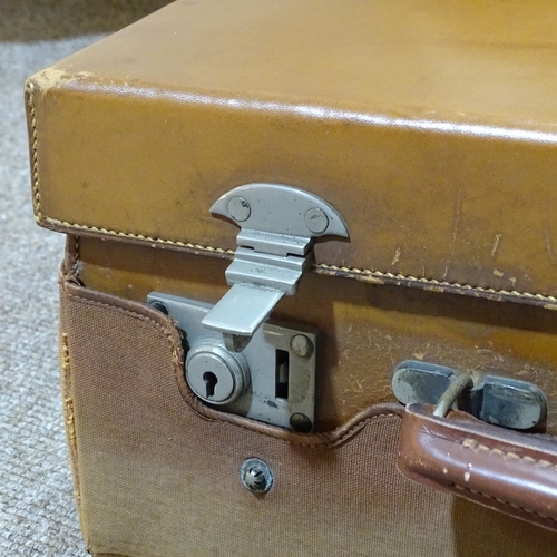 66 - A gentleman's leather travelling case, the interior fitted with original silver-topped cut-glass toi... 