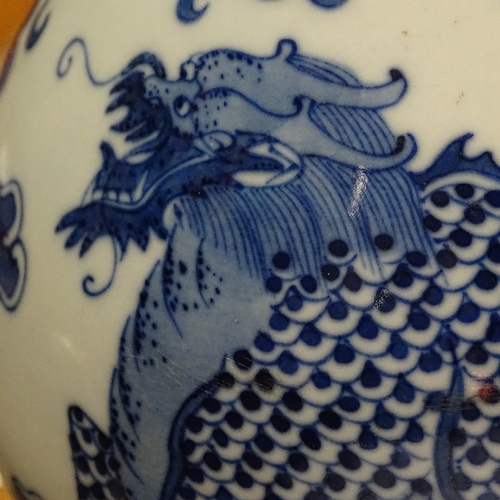 322 - A Chinese blue and white porcelain dragon design narrow-neck vase, 4 character mark, height 26cm