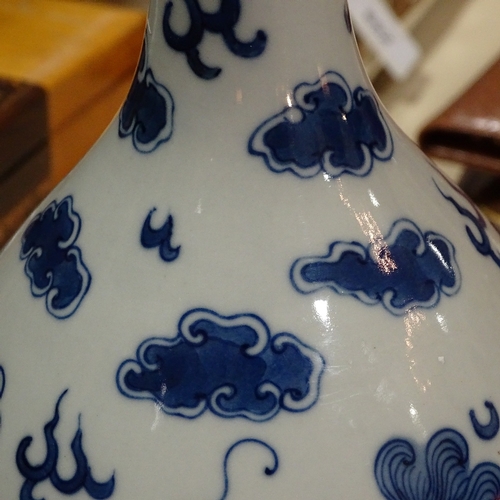 322 - A Chinese blue and white porcelain dragon design narrow-neck vase, 4 character mark, height 26cm