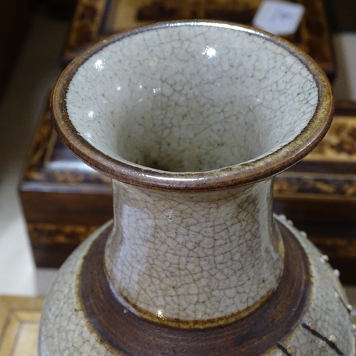 324 - A Chinese brown crackle glaze vase with relief prunus design, height 25cm