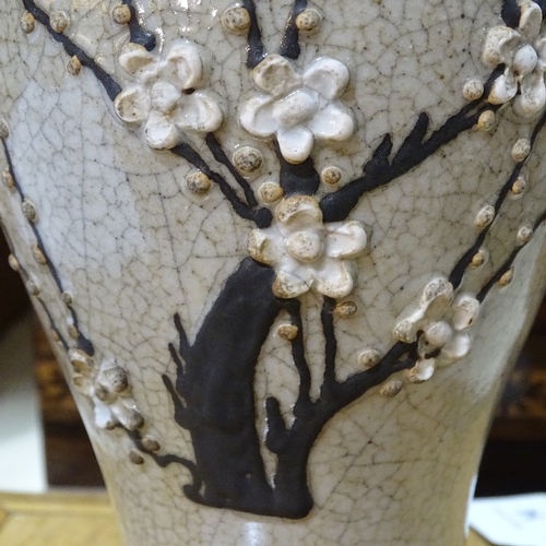 324 - A Chinese brown crackle glaze vase with relief prunus design, height 25cm