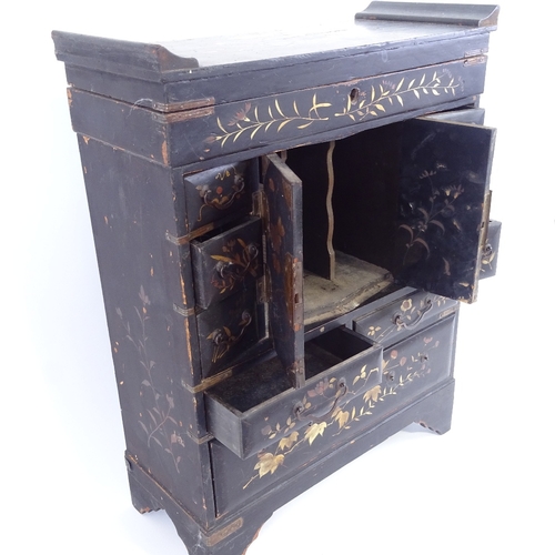 1 - A Japanese gilded black lacquer kodansu table-top cabinet, Meiji Period, with hinged lid, brass-moun... 