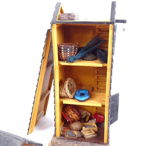 23 - A handmade Hastings fishing hut, complete with contents and lobster cages, height 28cm