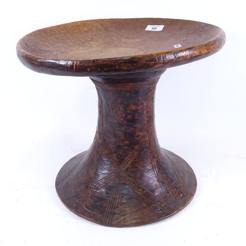 68 - An African Tribal carved hardwood stool, seat diameter 36cm, height 32cm