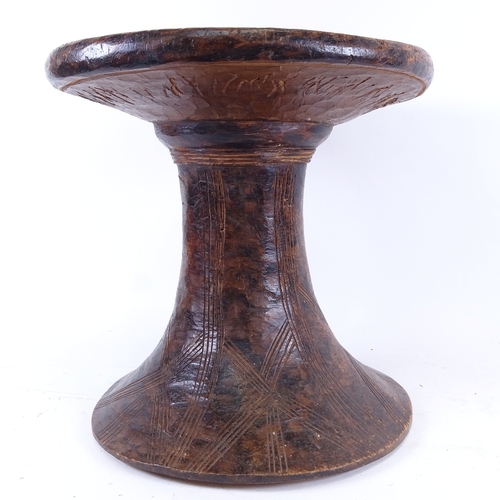 68 - An African Tribal carved hardwood stool, seat diameter 36cm, height 32cm