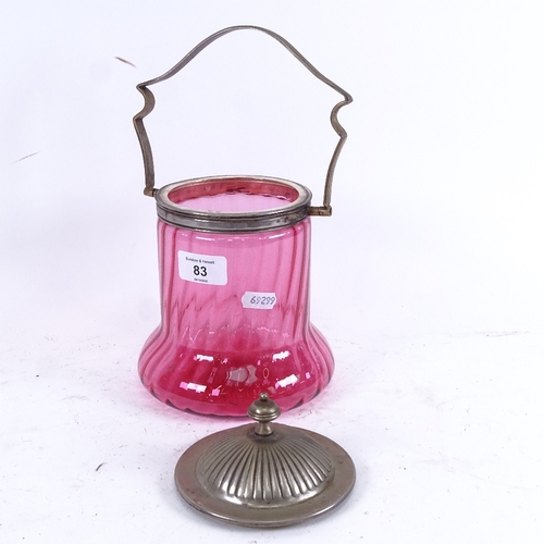 83 - An early 20th century spiral cranberry glass biscuit jar, with swing-handled electroplate mounts, he... 