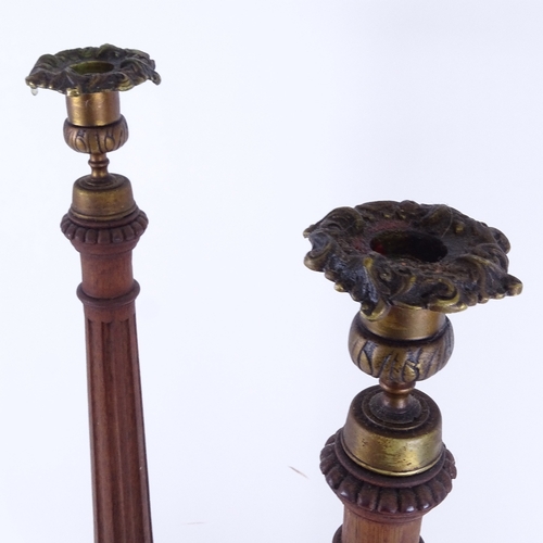 94 - A large pair of carved mahogany table candlesticks with brass mounts, height 57cm