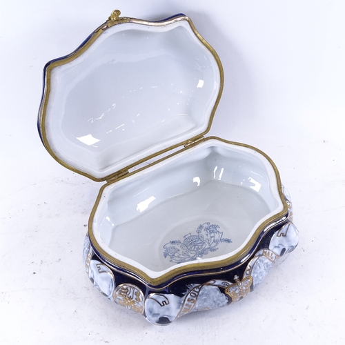 353 - A Continental porcelain box of shaped form, with painted and gilded decoration, width 28cm