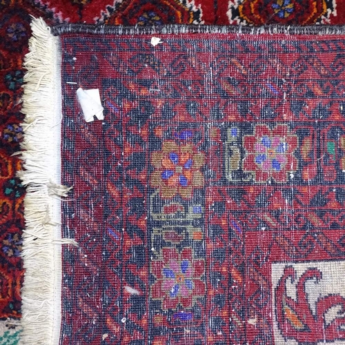 1352 - A red ground Persian design rug, 185cm x 107cm