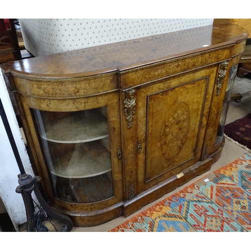 1357 - A Victorian figured walnut bow-end credenza, with glazed and panelled cupboard doors, floral marquet... 