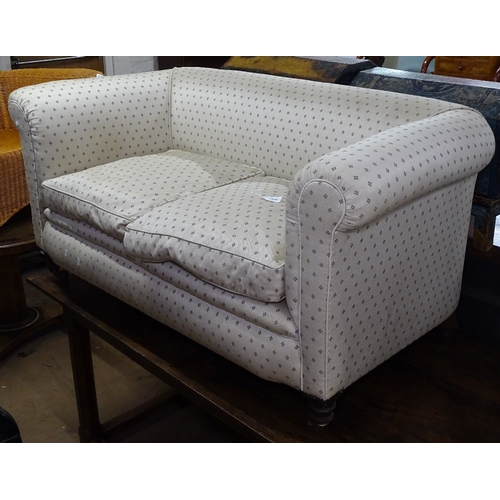 1366 - A small Victorian upholstered settee with rollover arms, on turned mahogany legs, L150cm, H75cm, sea... 