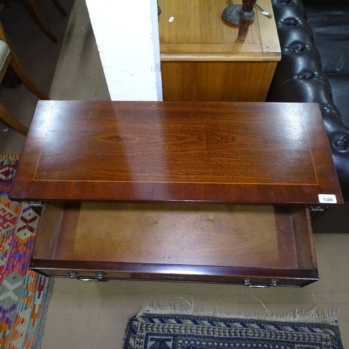 1389 - A mahogany satinwood-strung bookcase, with single frieze drawer and open shelves under, bracket feet... 