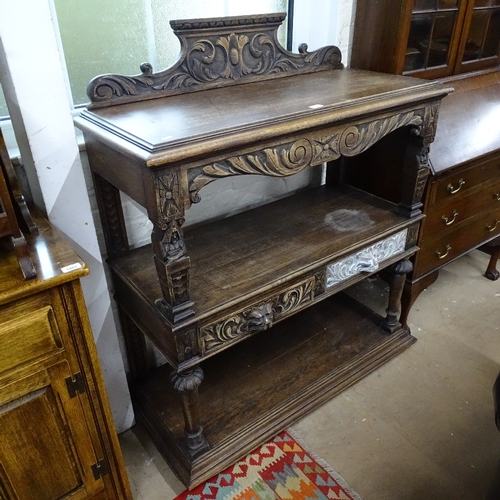 1397 - A 1920s carved oak 3-tier buffet, with lion mask frieze drawers, W110cm, H120cm