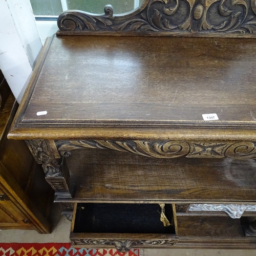 1397 - A 1920s carved oak 3-tier buffet, with lion mask frieze drawers, W110cm, H120cm