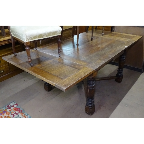 1406 - A large oak draw leaf dining table, on cross stretchers and baluster turned legs, L120cm extending t... 