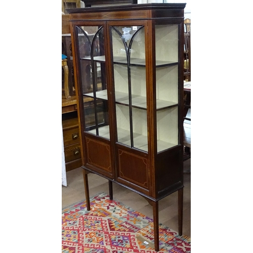 1408 - An Edwardian mahogany and satinwood-strung display cabinet, with 2 glazed and panelled doors, raised... 