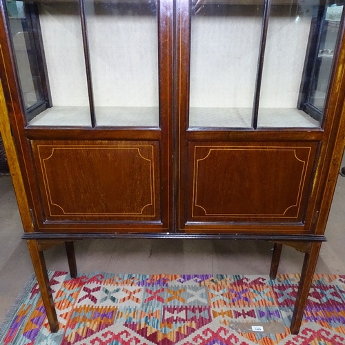 1408 - An Edwardian mahogany and satinwood-strung display cabinet, with 2 glazed and panelled doors, raised... 