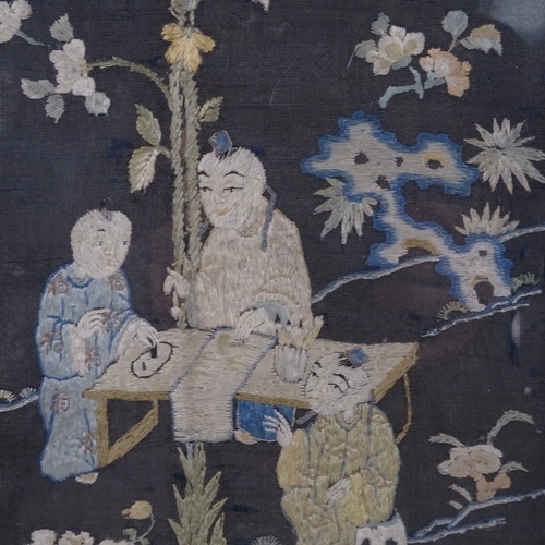 586 - A pair of Oriental embroidered pictures of figures in a garden, framed, height 41.5cm overall