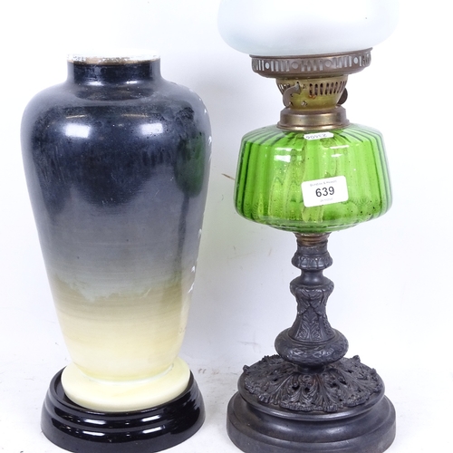 639 - A Victorian oil lamp with green glass font, 59cm, and a painted Edwardian glass vase on stand