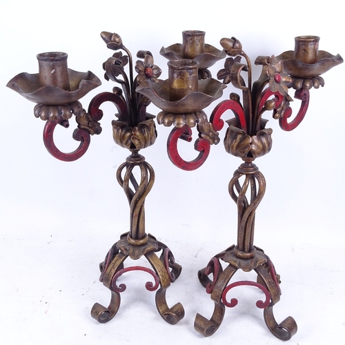 641 - A pair of painted and gilded wrought-iron candelabra with floral decoration, 43.5cm