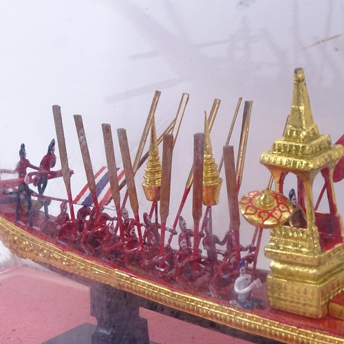 713 - A painted and gilded model ship with oarsmen, in glazed display case, length 52cm overall