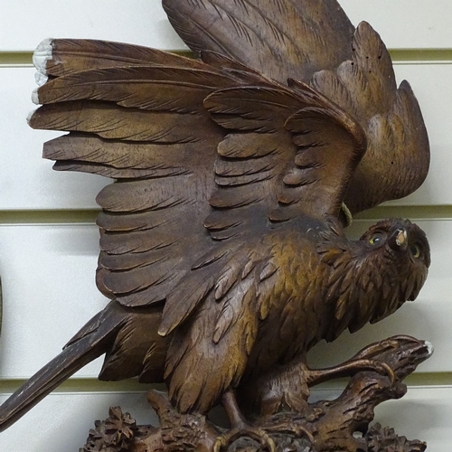 773 - A Black Forest carved wood bird of prey shaped bevel-edge wall mirror, overall height 75cm