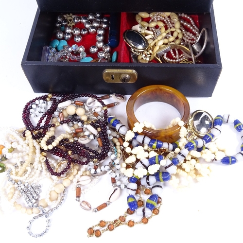 1015 - A cantilever jewel box with a quantity of costume jewellery, rosaries etc