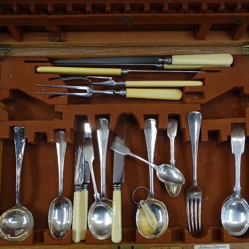 1034 - A quantity of Fiddle and Old English pattern cutlery, a carving set etc, in a fitted canteen on stan... 