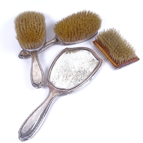 981 - A 3-piece silver-backed dressing table brush set, and an engine turned silver-backed brush (4)