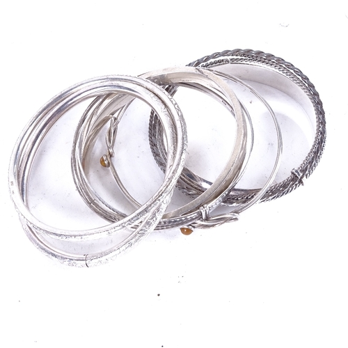 1082 - 7 various engraved and plain silver bangles