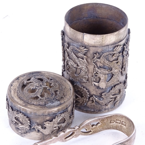 1100 - A pair of 19th century silver sugar nips, and a Chinese white metal cylindrical box and cover, with ... 