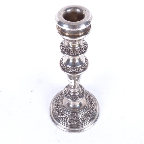 1104 - An embossed silver single candlestick, Birmingham 1975