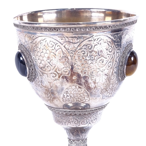 1123 - An Israeli sterling silver chalice, with allover chased and embossed decoration, and set with tigers... 