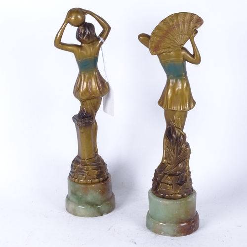 170 - A pair of art deco gilded spelter figures, on green onyx bases Height 29cm