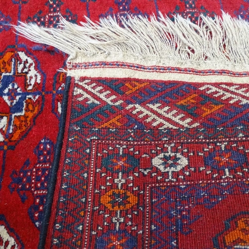 1988 - A red ground Tekke design rug, 150cm x 100cm