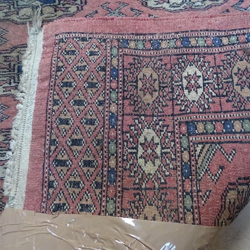 1989 - A red ground Afghan Tekke design runner, 310cm x 84cm