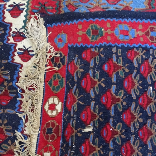 1991 - A Kilim red and blue ground floral pattern rug