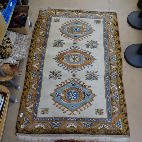 1992 - An Turkish design cream ground wool rug, 170cm x 110cm