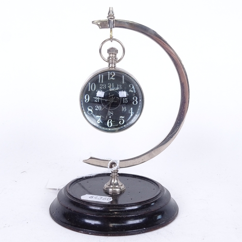 817 - A reproduction nickel and glass-cased ball clock on stand