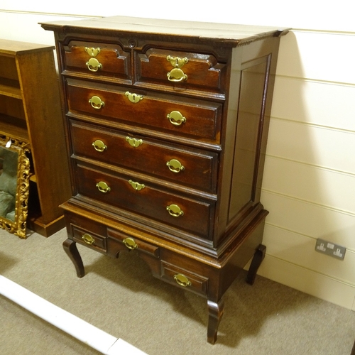 245 - An 18th century oak chest on stand, with carved shaped pediment, 2 short shaped frieze drawers and d... 