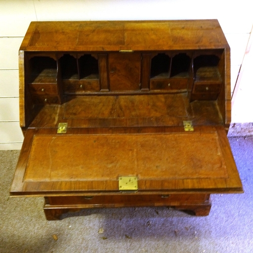 450 - A George III walnut bureau, stepped fitted interior with secret drawers and well, 4 long drawers bel... 