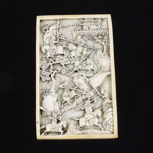 103 - An intricately carved Chinese relief ivory panel, 18th or early 19th century, depicting a dramatic b... 