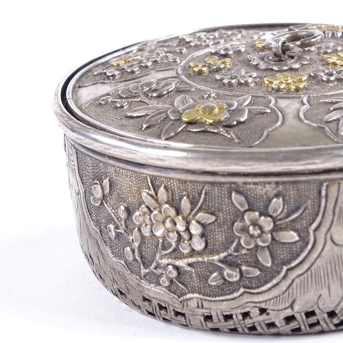 107 - A Chinese unmarked silver cricket cage, circa 1900, parcel gilt relief decorated floral lid, and pie... 