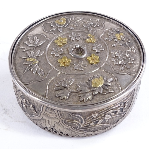 107 - A Chinese unmarked silver cricket cage, circa 1900, parcel gilt relief decorated floral lid, and pie... 