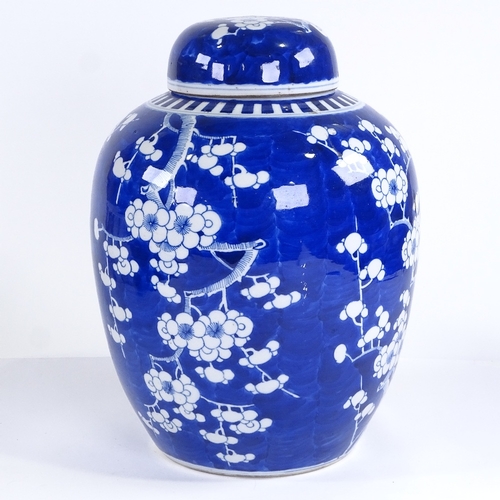 114 - A large Chinese blue and white porcelain jar and cover, with prunus decoration, height 34cm