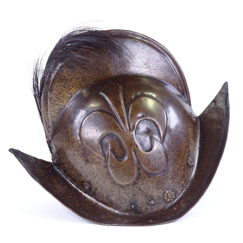 119 - A German steel Morion helmet, early 17th century, with relief moulded fleur de lis emblem, length 36... 