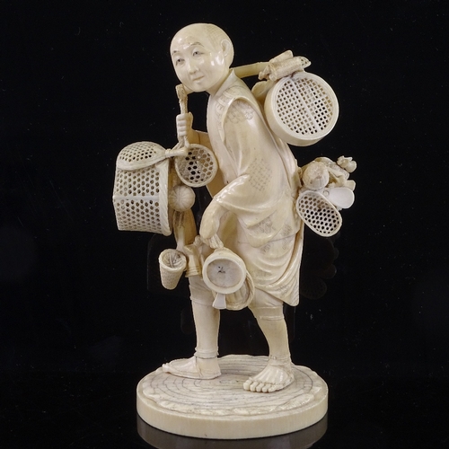 162 - A Japanese ivory okimono of a basket seller, Meiji Period, with inset signed jade plaque under base,... 